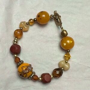 Brown beaded 8 in bracelet. decorative details on some beads. Costume jewelry